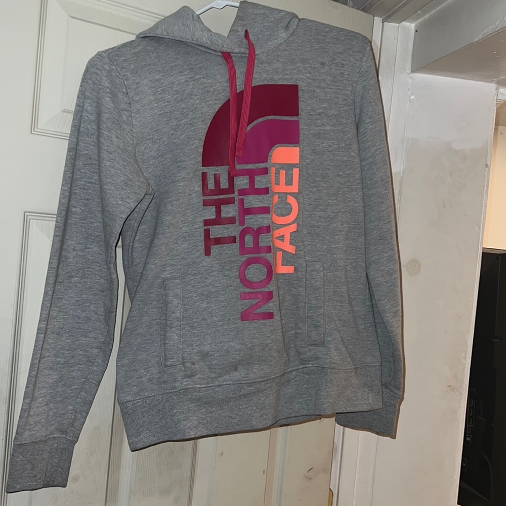 North face hoodie w multi colored symbol on front, great condition, very comfy